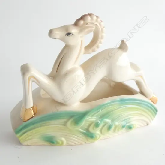 An Art Deco flower trough surmounted by an ibex